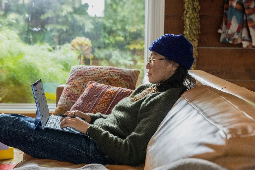 Girl working on laptop in a cozy environment